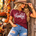 Thankful Tee - model leaning against wooden wall, fedora